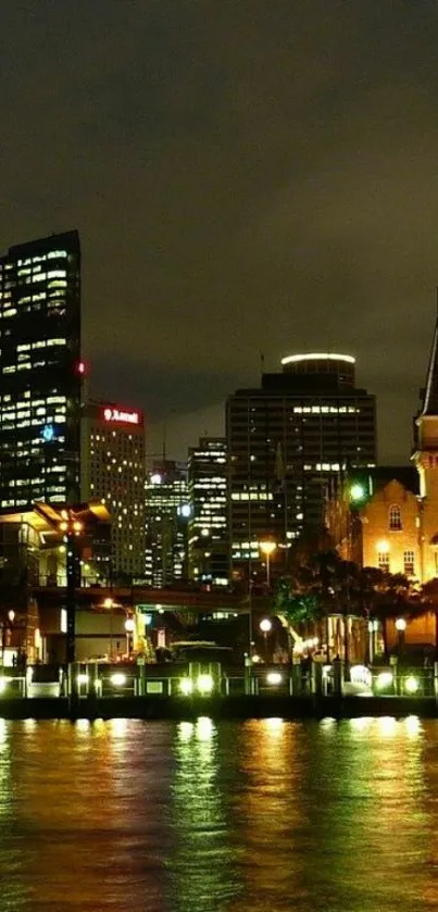 Vibrant night cityscape reflecting on calm water with illuminated buildings.