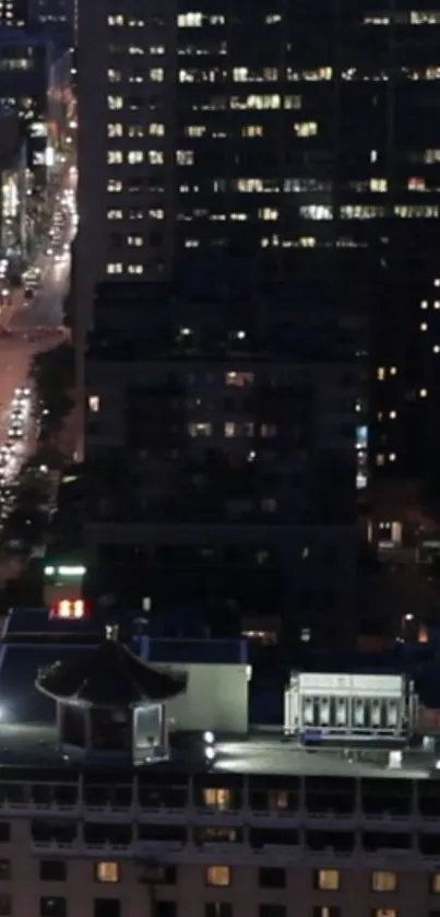 Night cityscape featuring illuminated buildings and streets.