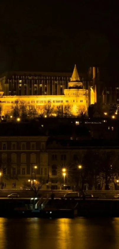 Nighttime cityscape with illuminated buildings and river reflection.