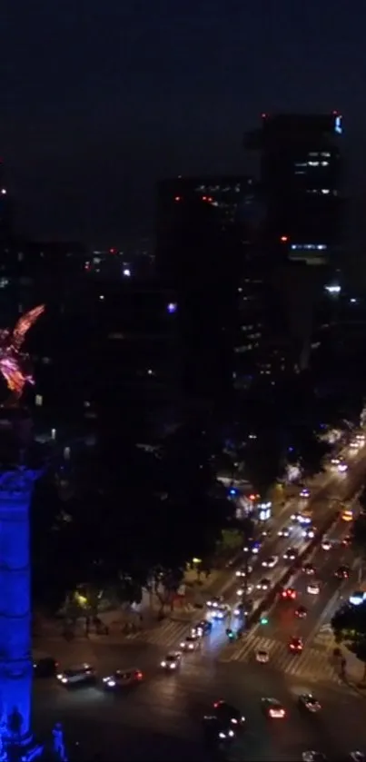 Night view of Angel of Independence monument with city lights.