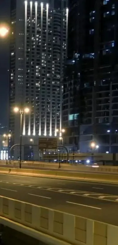 Illuminated skyscrapers with dark city road at night.