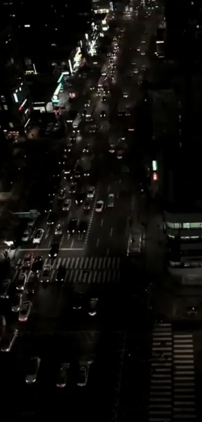 Night cityscape showing a busy street with lights and traffic.