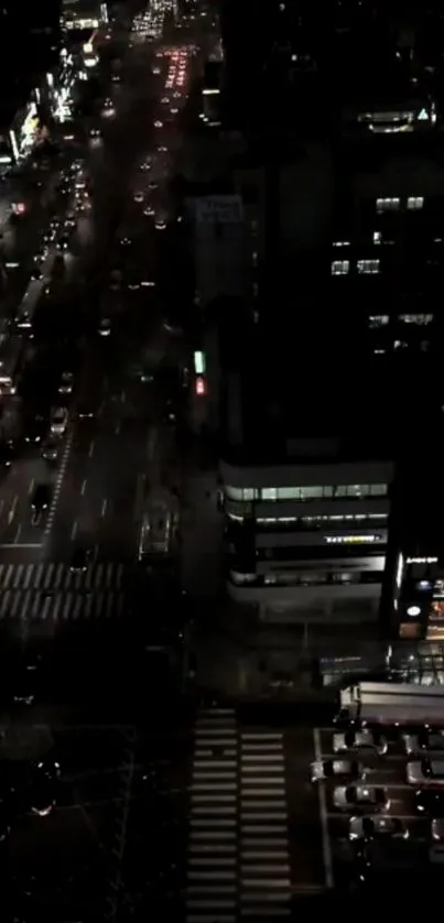 Night cityscape with urban roads and vibrant lights viewed from above.