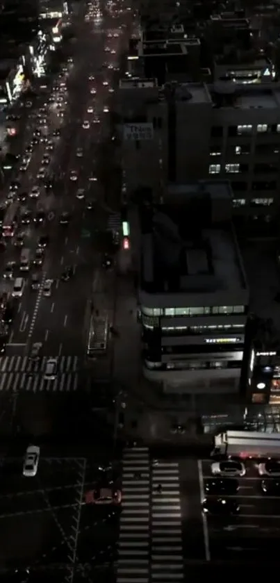 Aerial view of a busy city street at night with vibrant lights.