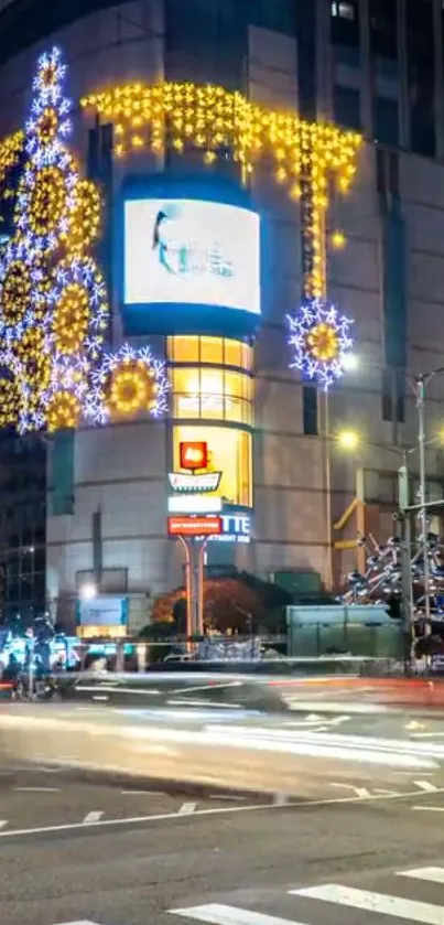 City at night with festive holiday lights and traffic.