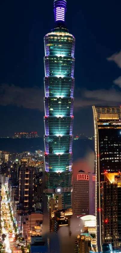 Night cityscape featuring illuminated skyscrapers against the dark blue sky.