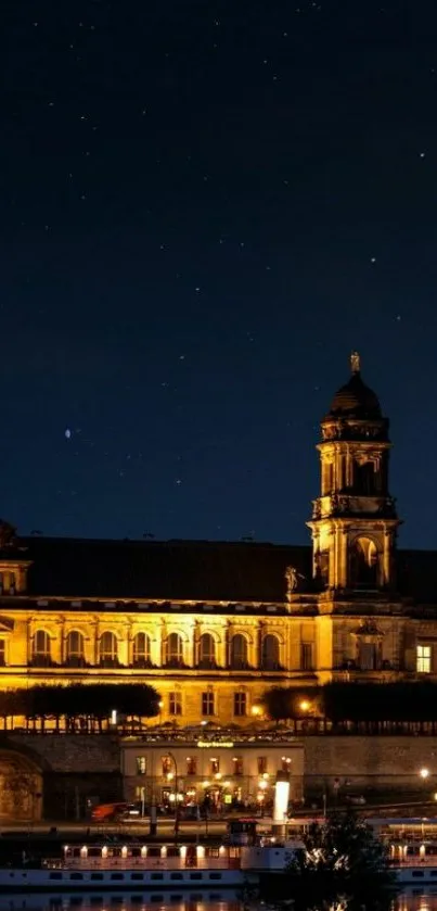 A beautifully illuminated historic building under a starry night sky.