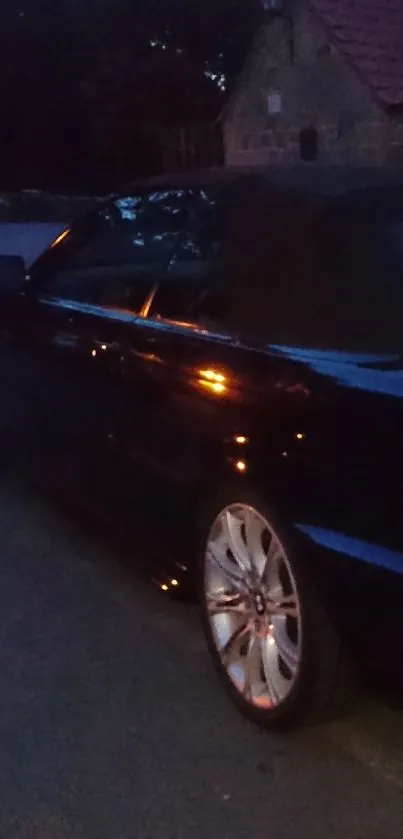 Sleek convertible parked at night on a quiet street.