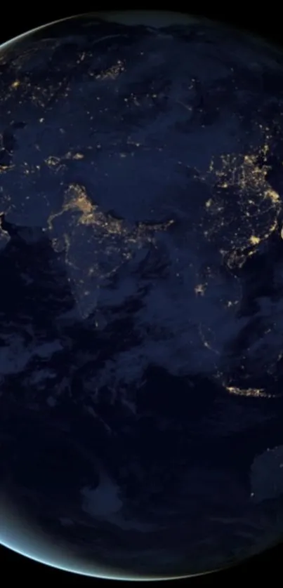 A night view of Earth from space, showcasing glowing city lights.