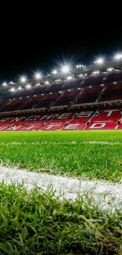 Vibrant night view of a football stadium with green grass field.