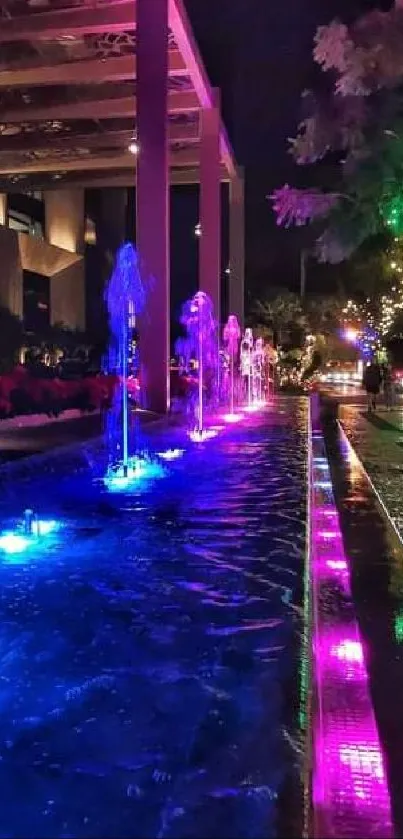 Vibrant night scene with colorful fountains and lights illuminating the street.