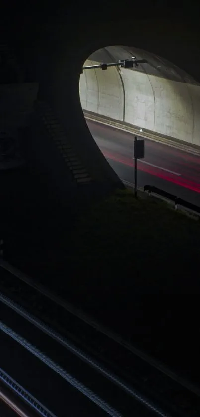 Path through a dark tunnel at night with streaking lights.