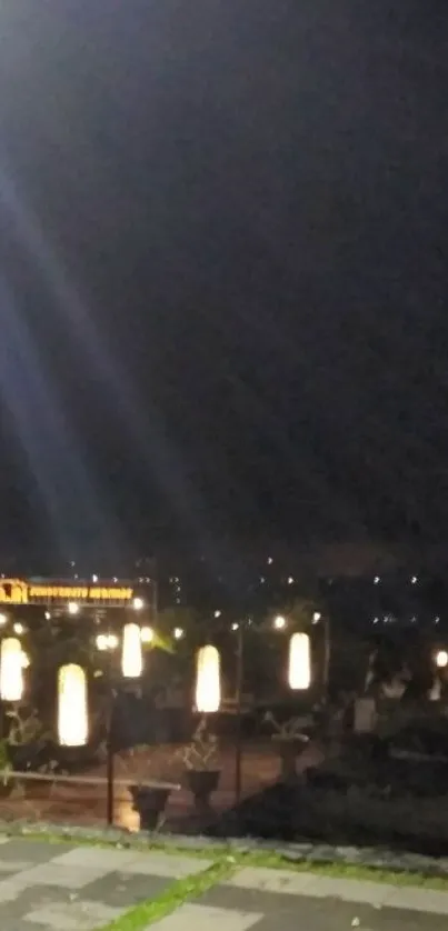 Night cityscape with glowing lights and dark sky.