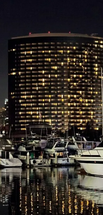 Nighttime marina cityscape with boats and glowing building reflections.