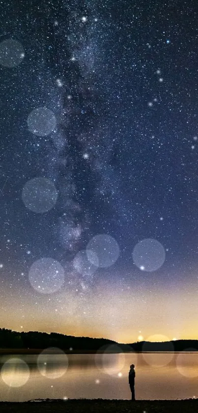 A stunning view of the night sky with stars reflecting over a tranquil lake.