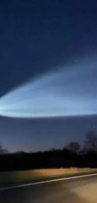 Night sky with a bright comet streaking across the dark horizon.