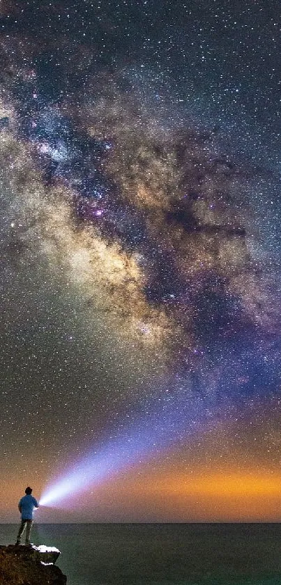 Milky Way arches over ocean at night.