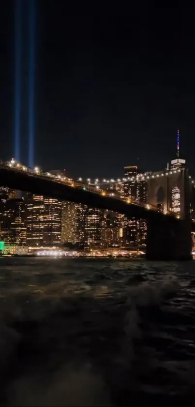 Vibrant cityscape at night with lit skyline and bridge over river.