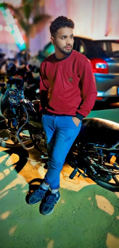 Stylish man posing with motorbikes at night on a city street.
