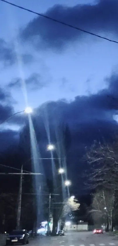 Night street with bright lights and dark clouds overhead.