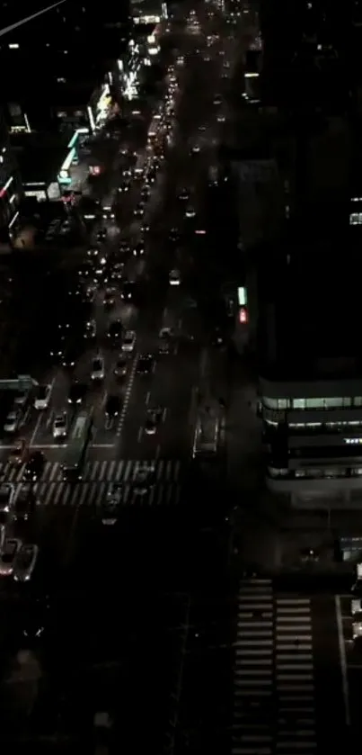 Aerial view of city at night with traffic and illuminated streets.