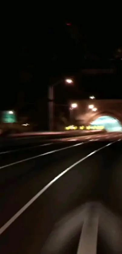 Night tunnel road wallpaper with city lights.