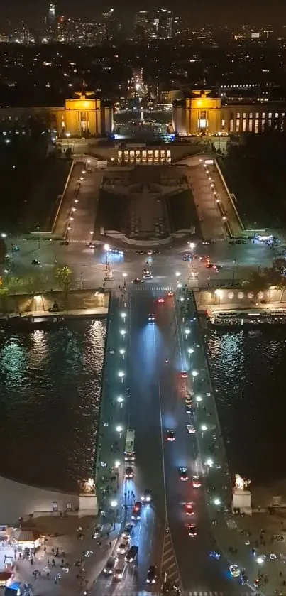 Aerial view of Paris at night, featuring illuminated streets and cityscape.