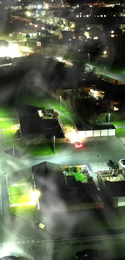 Aerial view of a city neighborhood at night with glowing streetlights and houses.