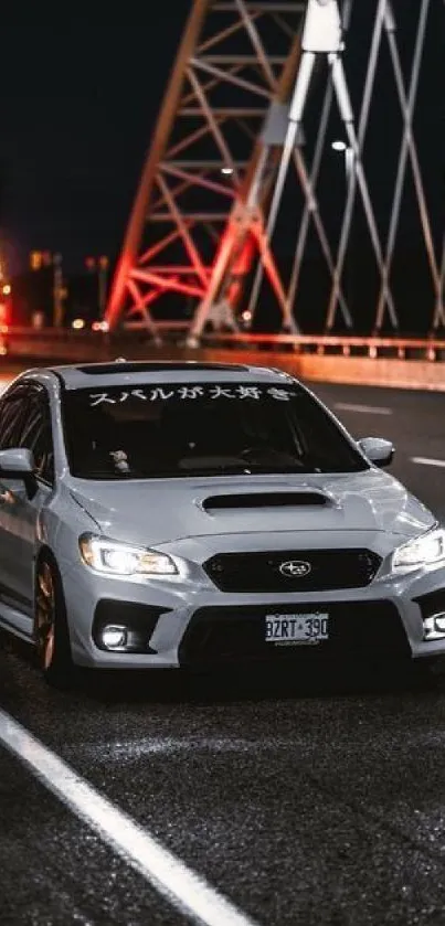 Sleek car on a bridge at night, illuminated by street lights and dark sky.