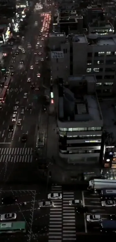 Aerial view of city night traffic with vibrant lights and bustling streets.