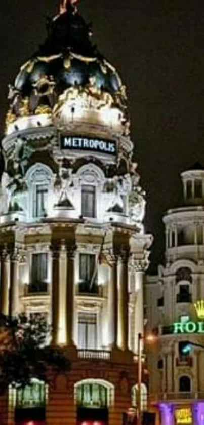 Nighttime cityscape with illuminated landmark building and urban scenery.