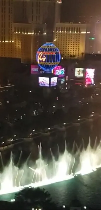 Vibrant night cityscape with colorful lights and fountains.