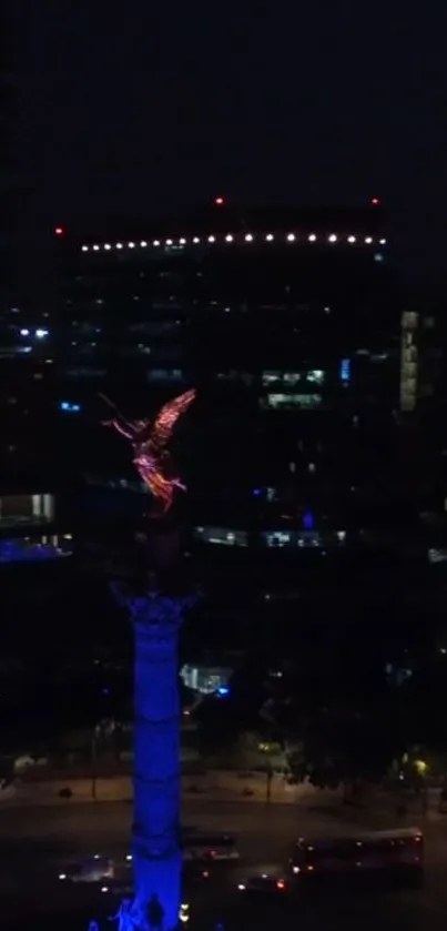 Nighttime view of a city with a glowing monument.