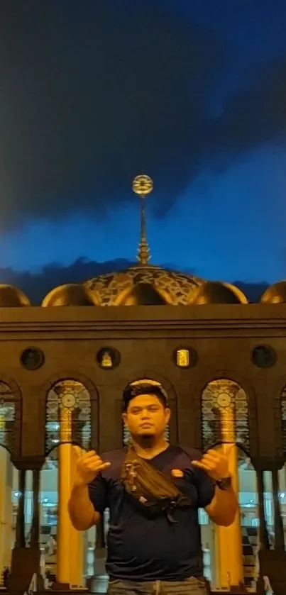 Nighttime mosque with golden lights and deep blue sky.