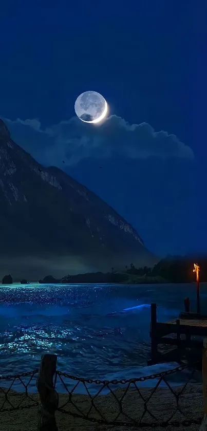 Moonlit lake with mountains at night.