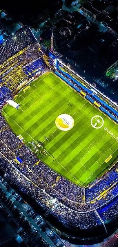 Aerial view of a vibrant stadium at night with colorful illumination.