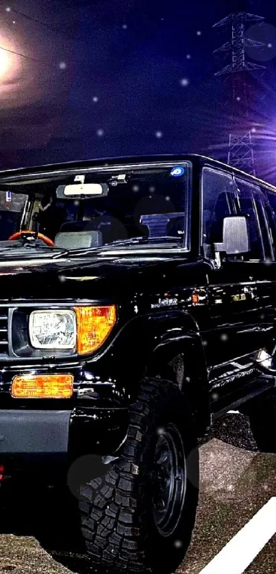 Sleek black SUV on nighttime urban street.