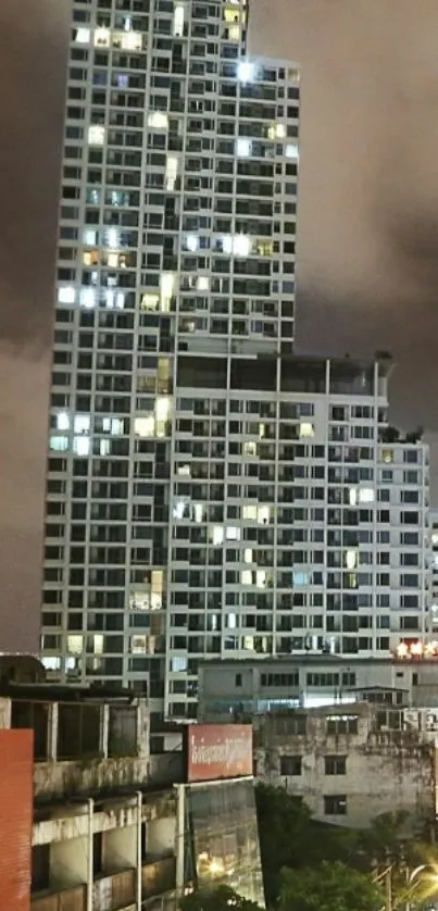 Towering building against a nighttime, cloudy skyline.