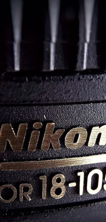 Close-up of Nikon lens with sharp branding and focus details.