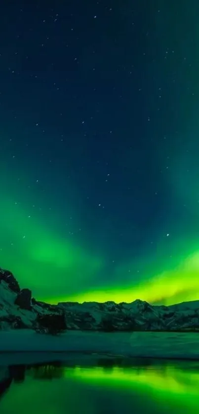 Vibrant green Northern Lights illuminate the night sky over a snowy mountain landscape.