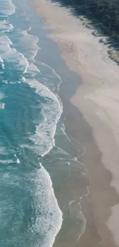 Aerial view of ocean waves and sandy beach, perfect for a serene phone wallpaper.