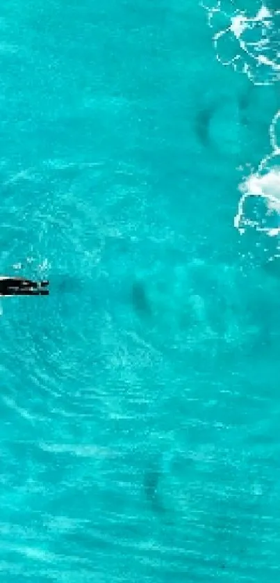 Aerial view of turquoise ocean with gentle waves.