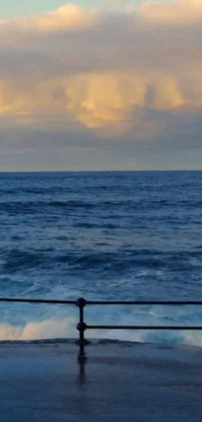 Ocean waves at sunset with golden clouds visible on the horizon.