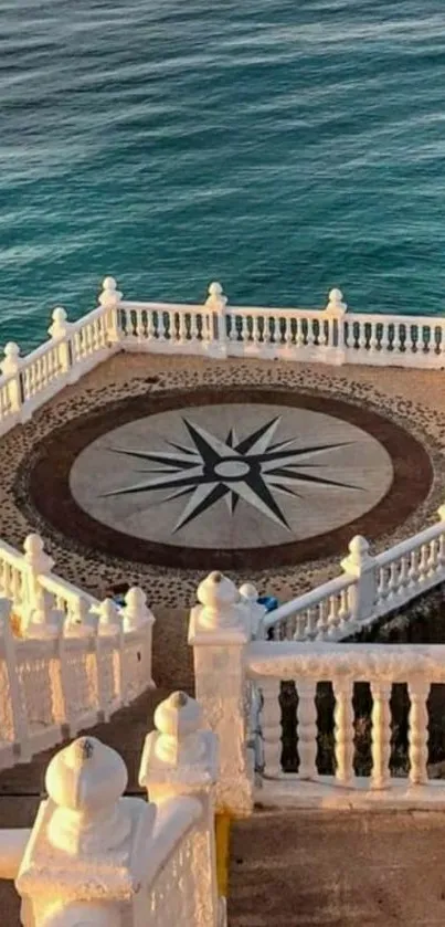 Ocean view balcony with compass design and blue water.