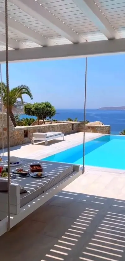 Luxurious poolside with ocean view and clear blue skies.