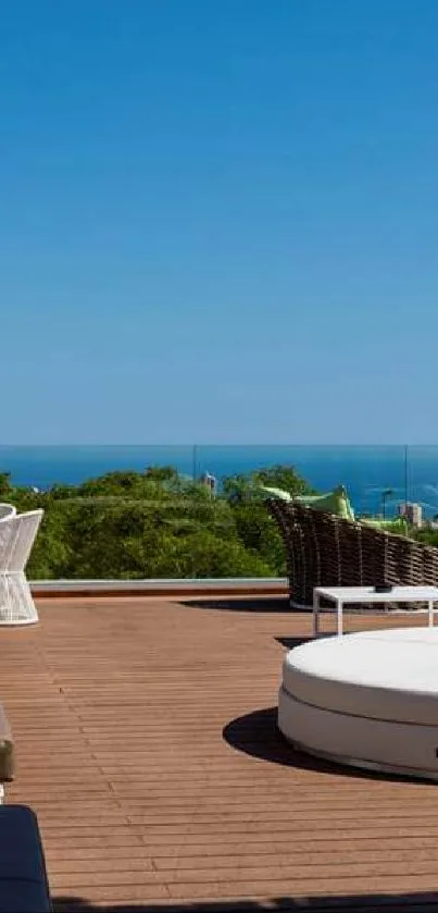 Ocean view rooftop with loungers and greenery under clear blue skies.