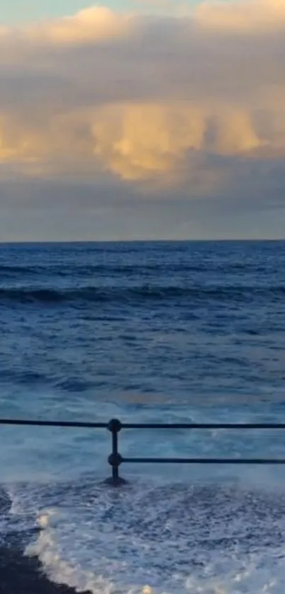 Calm ocean view at sunset with clouds.