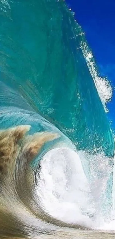 Captivating mobile wallpaper of a vibrant ocean wave with a clear blue sky.