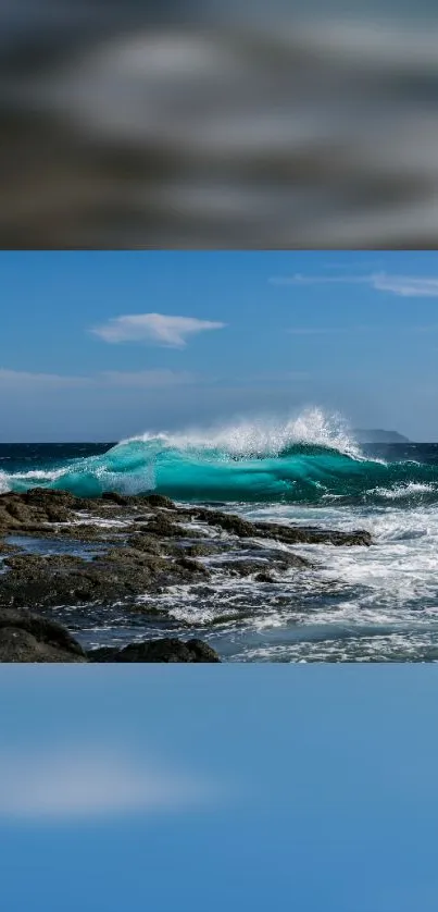 Dynamic ocean wave crashing on rocky shore under blue sky.