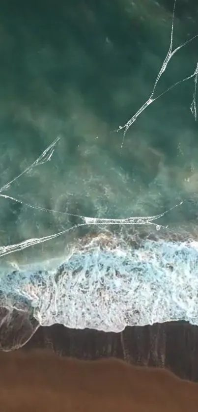 Aerial view of ocean waves and sandy beach.